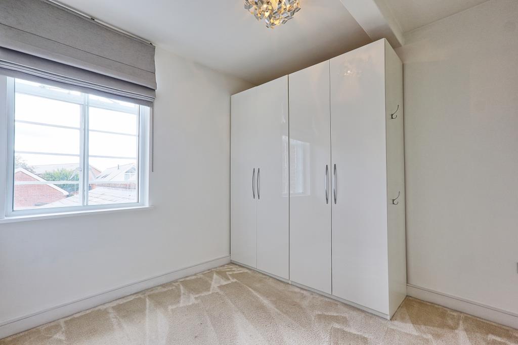 Lot: 6 - ATTRACTIVE TWO-BEDROOM APARTMENT IN CONVERTED FORMER HOSPITAL BUILDING - Carpeted 2nd bedroom with window and wardrobe